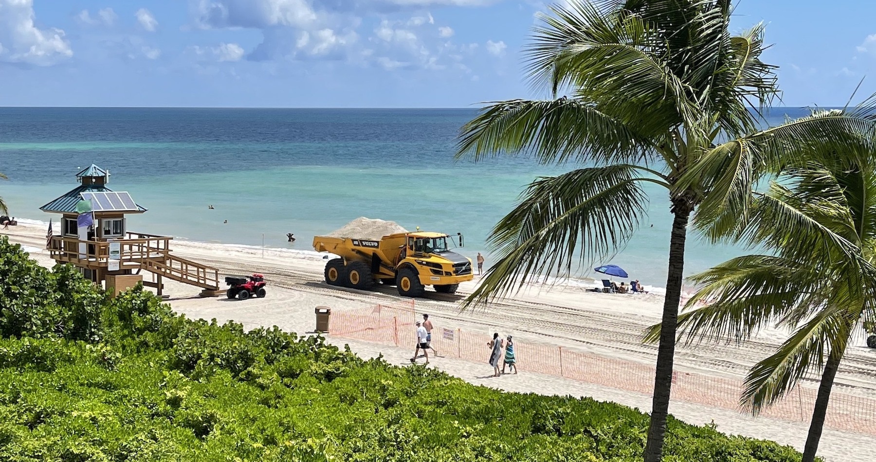 Dump truck on the beach undertaking beach sand renourishment project