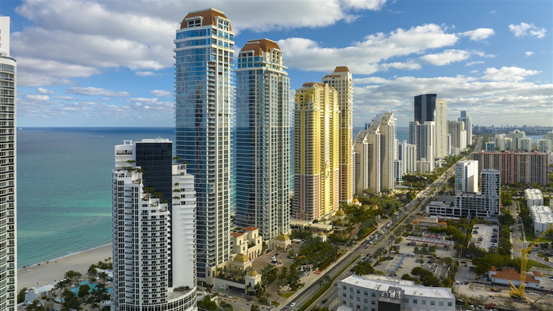 View from above of highrise condos and hotels along Sunny Isles Beach coastline.