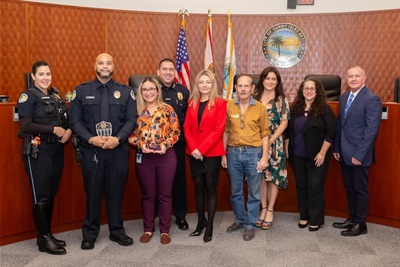 Employee of the year holding award at Commission Meeting