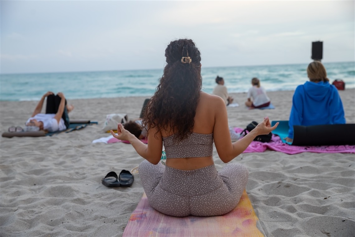 lady on beach doing yoga