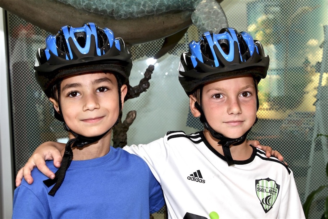 2 kids wearing helmets