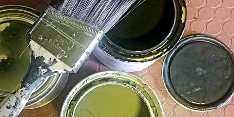 Open paint cans and paint brush