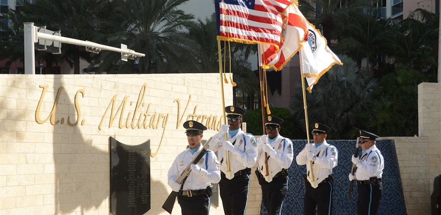 Military personnel carrying color guard.