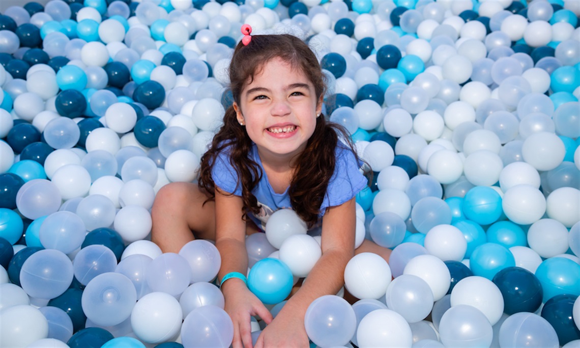 Young girl in Winter Fest ball pit